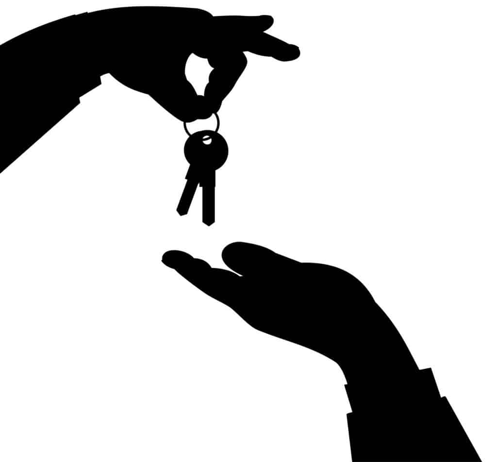 hands exchanging house keys